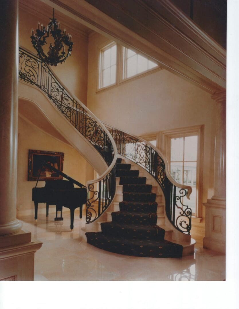 Elegant staircase with grand piano underneath.
